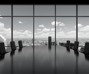 a small black and white photo of a senior executive board room