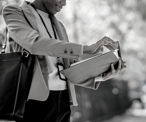 a small black and white photo of a person holding a briefcase