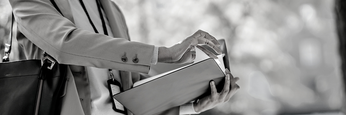 a black and white photo of a person holding a briefcase