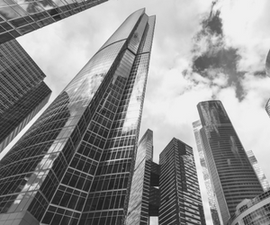 a small black and white photo of a range of finance buildings