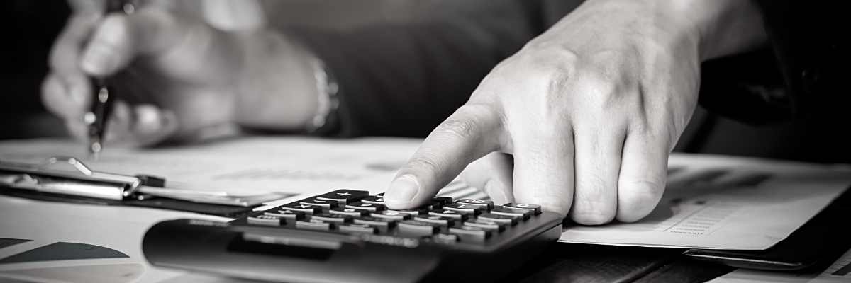 a black and white photo of someone pressing a button on a calculator