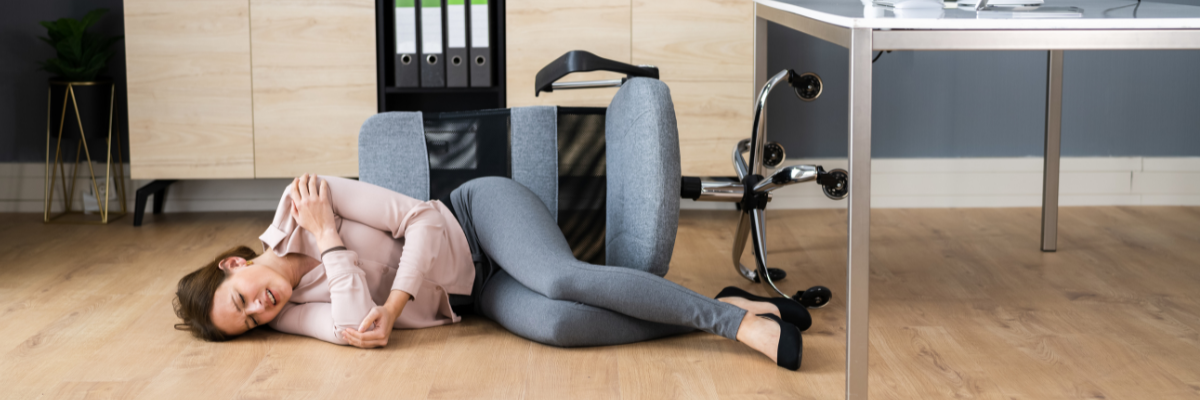 a woman laying on the floor next to a desk