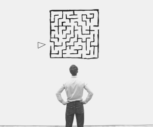 a man standing in front of a drawing of a maze