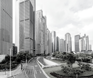 a black and white photo of a corporate city with trees in the middle of the business area