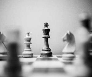 a black and white photo of a chess board depicting a king