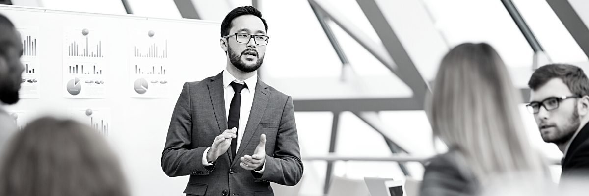 a black and white photo of a person presenting accounting statistics original